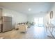 Large living room with tile floors, modern furnishings, and sliding glass doors to the yard at 5342 Maddie Dr, Haines City, FL 33844