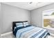 Cozy bedroom with natural light and tile flooring at 542 Bent Oak Loop, Davenport, FL 33837