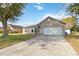 Inviting single-story home featuring an attached garage and a well-maintained front lawn at 542 Bent Oak Loop, Davenport, FL 33837