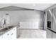 View of the modern kitchen with stainless steel appliances, tile floors and ample storage at 542 Bent Oak Loop, Davenport, FL 33837