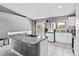 Bright kitchen features granite counters, new stainless steel appliances, and tile floors at 542 Bent Oak Loop, Davenport, FL 33837