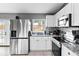 Bright and airy kitchen with white cabinets, stainless appliances, and stylish backsplash at 542 Bent Oak Loop, Davenport, FL 33837