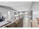 Bright and airy living room featuring a large comfy couch and direct access to the kitchen at 542 Bent Oak Loop, Davenport, FL 33837