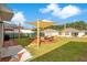 Spacious backyard with a shade sail, lounge seating, and manicured landscaping at 574 Lady Grace Pl, Deland, FL 32724