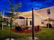 Atmospheric backyard scene with string lights illuminating a cozy lounge area under a sail shade at dusk at 574 Lady Grace Pl, Deland, FL 32724