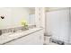 Clean bathroom with a double sink vanity featuring a granite countertop and white cabinets at 574 Lady Grace Pl, Deland, FL 32724