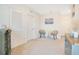 Bright, neutral bedroom featuring woven chairs, artwork, and ample natural light at 574 Lady Grace Pl, Deland, FL 32724