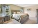 Comfortable bedroom with a rustic wood bed frame, neutral bedding, and soft natural light at 574 Lady Grace Pl, Deland, FL 32724