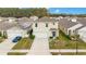 Two-story home with neutral siding, an attached garage, and a well-maintained lawn with manicured shrubbery at 574 Lady Grace Pl, Deland, FL 32724