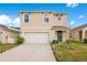Two-story home with manicured lawn, a two-car garage, and welcoming blue front door at 574 Lady Grace Pl, Deland, FL 32724