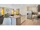 Open kitchen with granite island and stainless-steel appliances, connecting to the dining area at 574 Lady Grace Pl, Deland, FL 32724