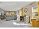 Bright living room with stylish gray sofa, a bar table, and yellow accents at 574 Lady Grace Pl, Deland, FL 32724