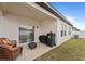 Covered backyard patio with slider to inside, plus multiple barbecue grills and an AC Unit at 5861 Bar Ranch Rd, St Cloud, FL 34771