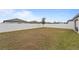 Large backyard with an appealing tree, long fence, and grassy area at 5861 Bar Ranch Rd, St Cloud, FL 34771