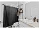 Bathroom featuring a vanity with a single sink and a shower with a black shower curtain at 5861 Bar Ranch Rd, St Cloud, FL 34771