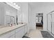 Bright bathroom with a single sink vanity, shower and open doorway to the bedroom at 5861 Bar Ranch Rd, St Cloud, FL 34771