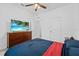 The bedroom has a window, ceiling fan, and dark wood furniture at 5861 Bar Ranch Rd, St Cloud, FL 34771