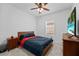 The bedroom includes a window, ceiling fan, a nightstand on each side, and neutral carpet at 5861 Bar Ranch Rd, St Cloud, FL 34771