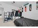 Bedroom features a black bedset, ceiling fan, and clothing rack for extra storage at 5861 Bar Ranch Rd, St Cloud, FL 34771