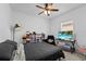This bedroom features a ceiling fan, a large window, and ample storage on shelving units at 5861 Bar Ranch Rd, St Cloud, FL 34771