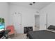 This bedroom has neutral walls and carpet with a Supreme chair and doorway to another room at 5861 Bar Ranch Rd, St Cloud, FL 34771