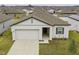 Charming single-story home with a two-car garage and neutral-colored exterior in a Gathering-friendly neighborhood at 5861 Bar Ranch Rd, St Cloud, FL 34771