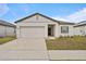 Charming single-story home with a two-car garage and manicured lawn at 5861 Bar Ranch Rd, St Cloud, FL 34771