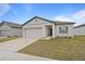 Charming single-story home with a two-car garage and manicured lawn at 5861 Bar Ranch Rd, St Cloud, FL 34771