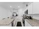 A view of the modern kitchen with stainless appliances, granite countertops, and a bar counter area at 5861 Bar Ranch Rd, St Cloud, FL 34771