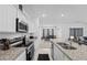 Modern kitchen with stainless steel appliances, granite countertops, and an open layout at 5861 Bar Ranch Rd, St Cloud, FL 34771