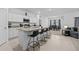 Open kitchen with granite countertops, stainless appliances and island that connects to the dining room and living room at 5861 Bar Ranch Rd, St Cloud, FL 34771