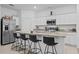 Bright kitchen features stainless steel appliances, granite countertops, and an island with barstool seating at 5861 Bar Ranch Rd, St Cloud, FL 34771