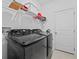 Laundry room with black front-loading washer and dryer and a wire shelf at 5861 Bar Ranch Rd, St Cloud, FL 34771