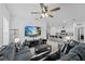 Spacious living room with a large gray sofa and a view into the dining area and kitchen at 5861 Bar Ranch Rd, St Cloud, FL 34771