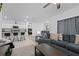 Cozy living room offering an open-concept design with views into the kitchen and dining area at 5861 Bar Ranch Rd, St Cloud, FL 34771