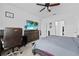 This spacious main bedroom features a large bed and a TV mounted on the dresser at 5861 Bar Ranch Rd, St Cloud, FL 34771