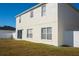Two-story house with a spacious backyard and patio area, great for relaxing or entertaining at 608 Bluebill Ct, Kissimmee, FL 34759