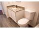 Bathroom features wood-look tile, granite counters, and a low-flow toilet at 608 Bluebill Ct, Kissimmee, FL 34759