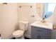 Bathroom with a marble counter, grey vanity and a brushed nickel faucet at 608 Bluebill Ct, Kissimmee, FL 34759
