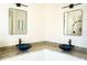 Modern bathroom with dual sinks, granite counters, framed mirrors, and unique lighting at 608 Bluebill Ct, Kissimmee, FL 34759
