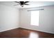 A bright bedroom features luxury vinyl flooring, neutral paint, and natural light at 608 Bluebill Ct, Kissimmee, FL 34759