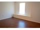 Bright bedroom with a window and hardwood floors provides a cozy space at 608 Bluebill Ct, Kissimmee, FL 34759