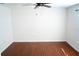 A bright bedroom features luxury vinyl flooring, neutral paint, and a ceiling fan at 608 Bluebill Ct, Kissimmee, FL 34759