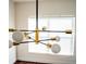 Modern light fixture in dining room with view of a large window with white blinds at 608 Bluebill Ct, Kissimmee, FL 34759