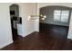 Dining room with wood-look floors and a chandelier, open to the kitchen and living room at 608 Bluebill Ct, Kissimmee, FL 34759