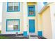 Home's blue front door and porch, flanked by blue trim windows and an ADT security sign at 608 Bluebill Ct, Kissimmee, FL 34759
