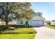 Charming two-story home with blue trim, a garage, and a well-manicured front lawn at 608 Bluebill Ct, Kissimmee, FL 34759