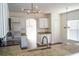 Kitchen with granite counters, stainless appliances, modern lighting, white cabinets, and dark floors at 608 Bluebill Ct, Kissimmee, FL 34759