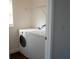 Laundry room with a washing machine, dryer and wire rack shelving at 608 Bluebill Ct, Kissimmee, FL 34759