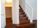 Carpeted staircase with a wooden handrail leading to the home's second level at 608 Bluebill Ct, Kissimmee, FL 34759